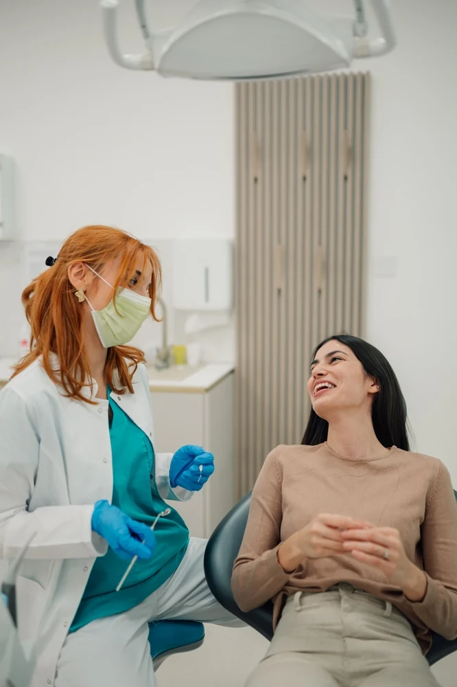 Happy patient with perfect smile at modern dental clinic